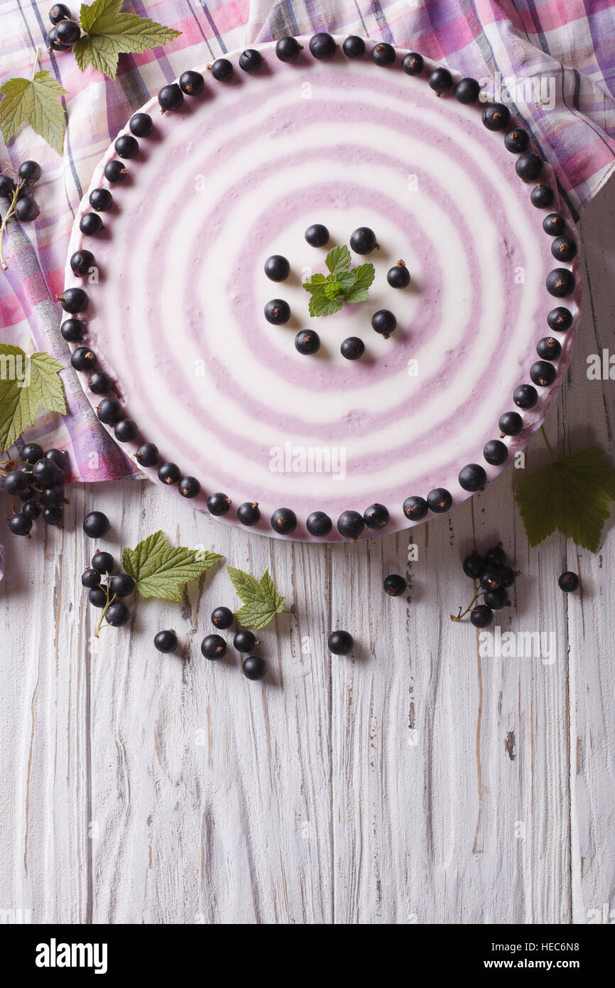 Delicious cheesecake striped black currant on the table. vertical top view Stock Photo