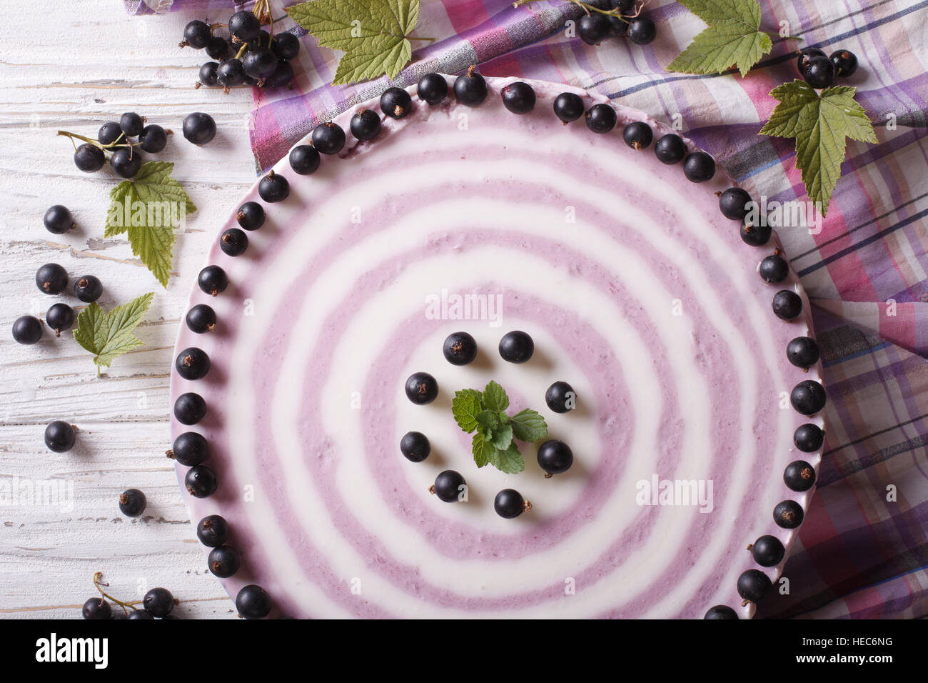 Delicious cheesecake striped black currant close up on the table. horizontal top view Stock Photo