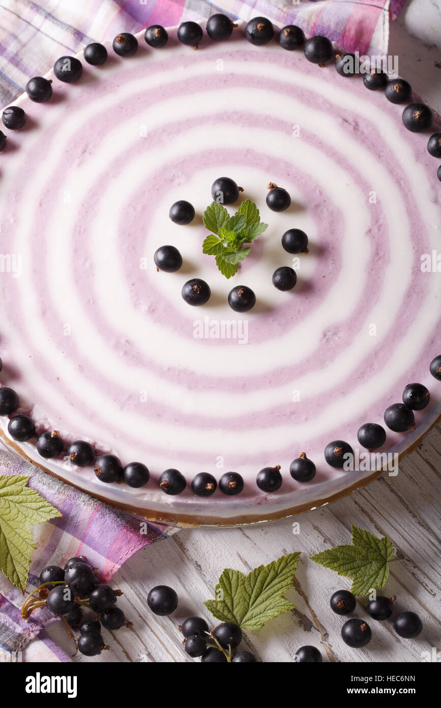Beautiful striped black currant cheesecake close-up on the table. vertical Stock Photo