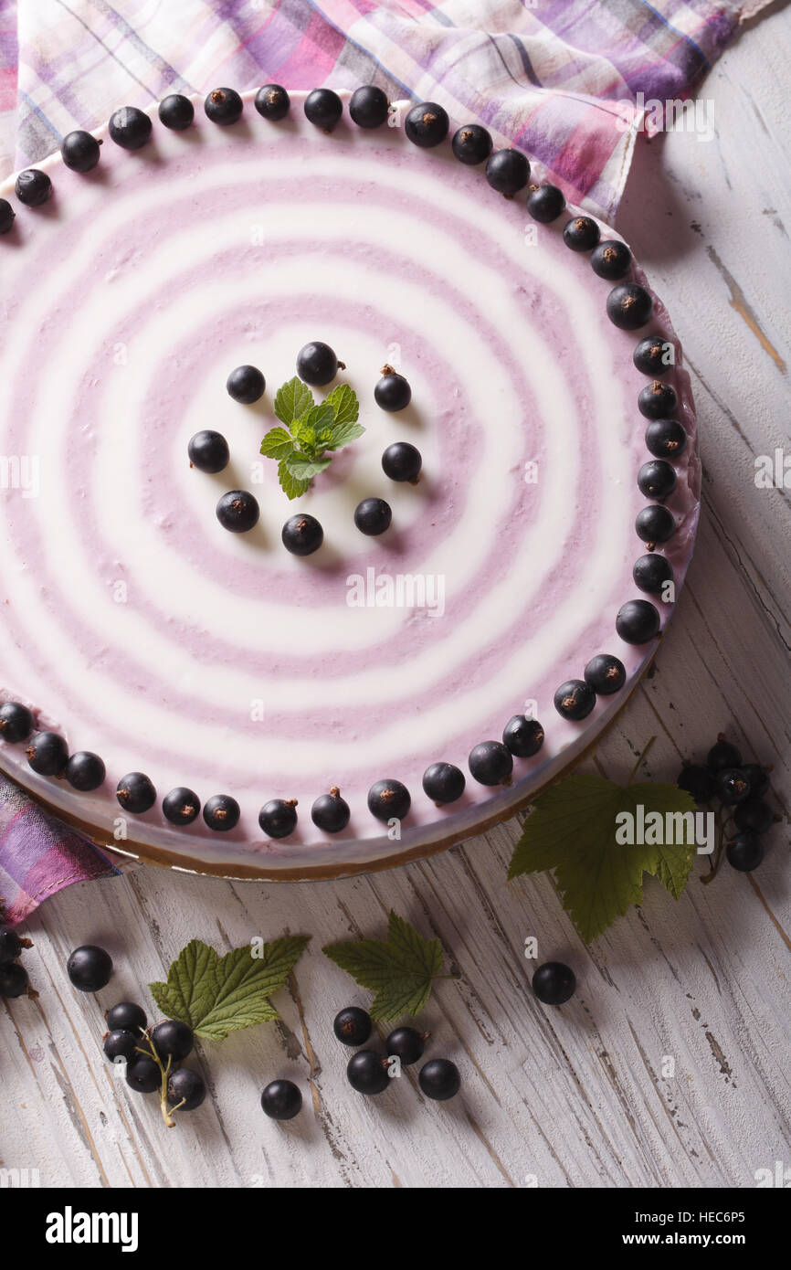 Round striped currant cheesecake close-up on the table. vertical top view Stock Photo
