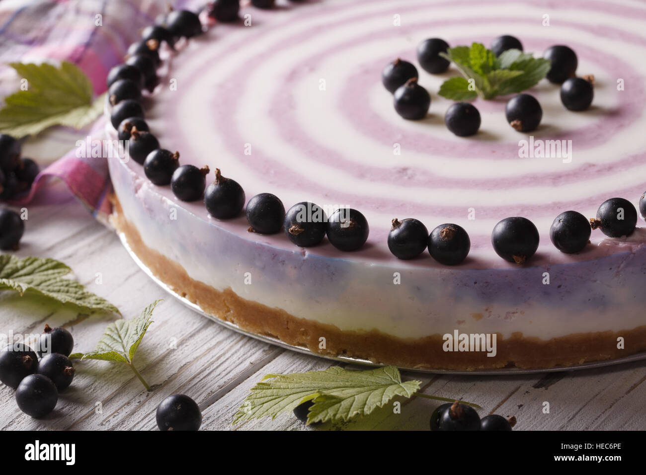 Delicious striped currant cheesecake close-up on a plate. horizontal Stock Photo