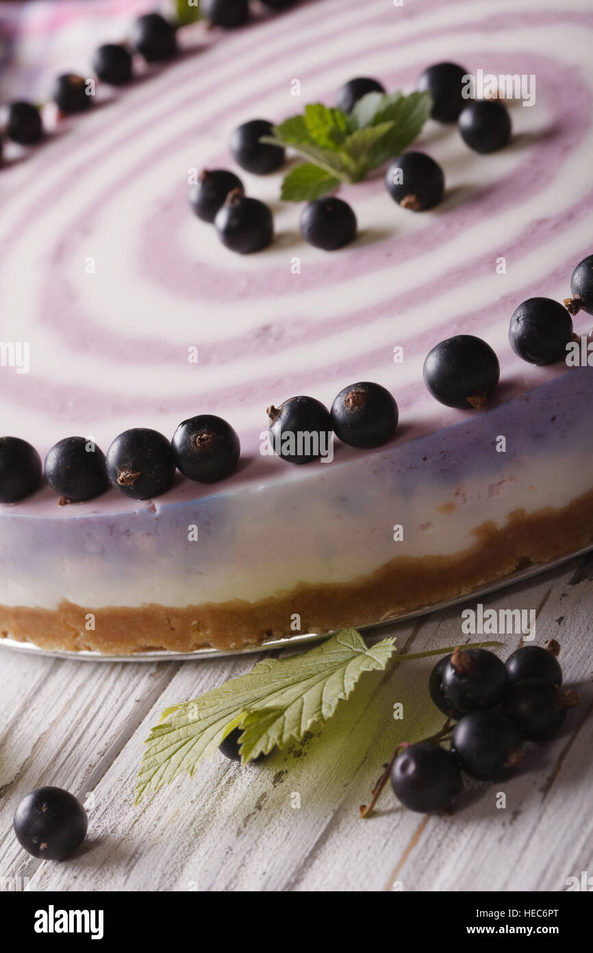 Beautiful striped currant cheesecake close-up on a plate. Vertical Stock Photo