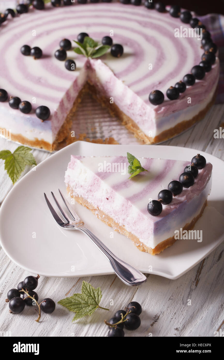 Beautiful currant cheesecake chopped close-up on a plate. vertical Stock Photo