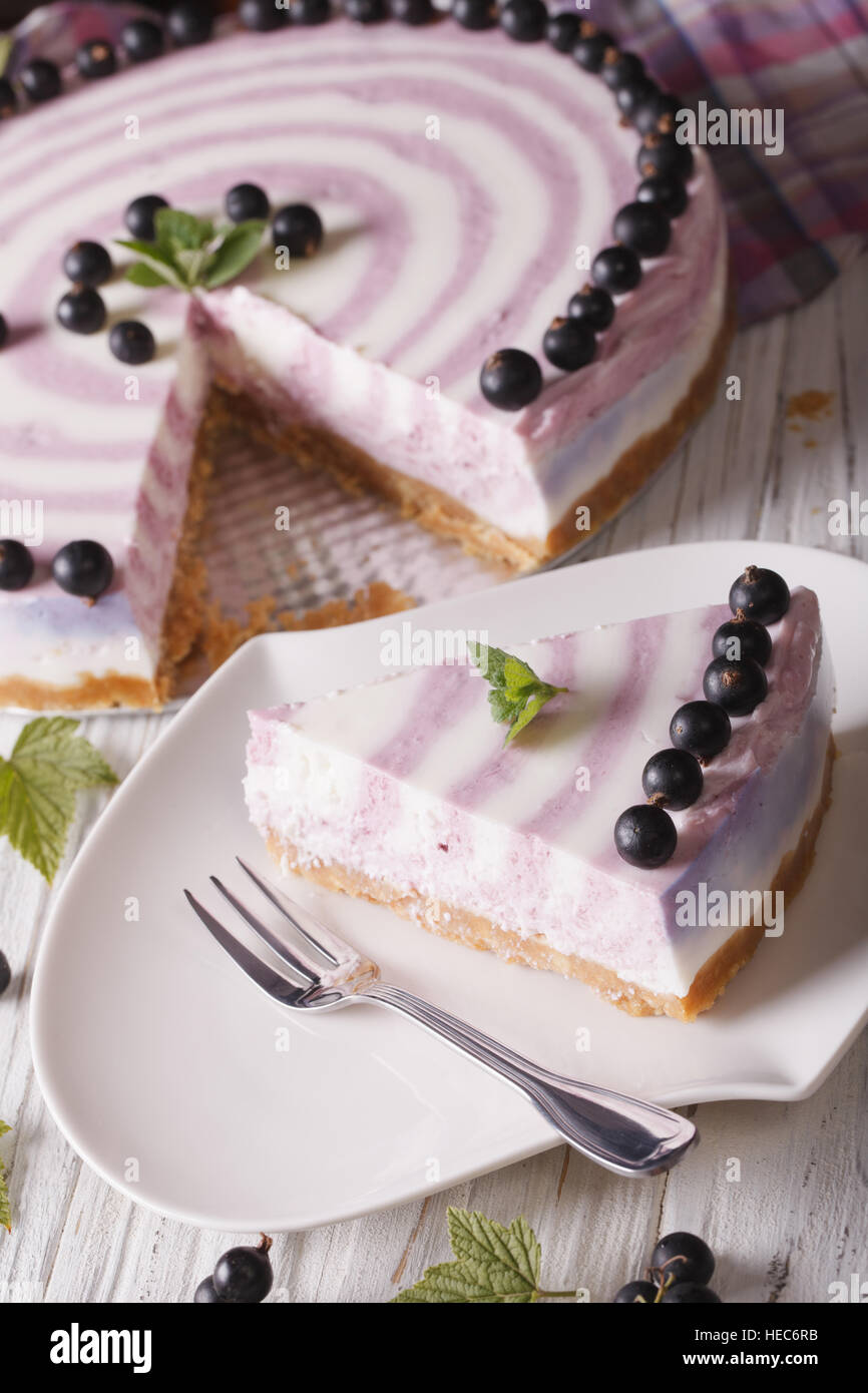 Slice of currant cheesecake close-up on a plate. vertical top view Stock Photo