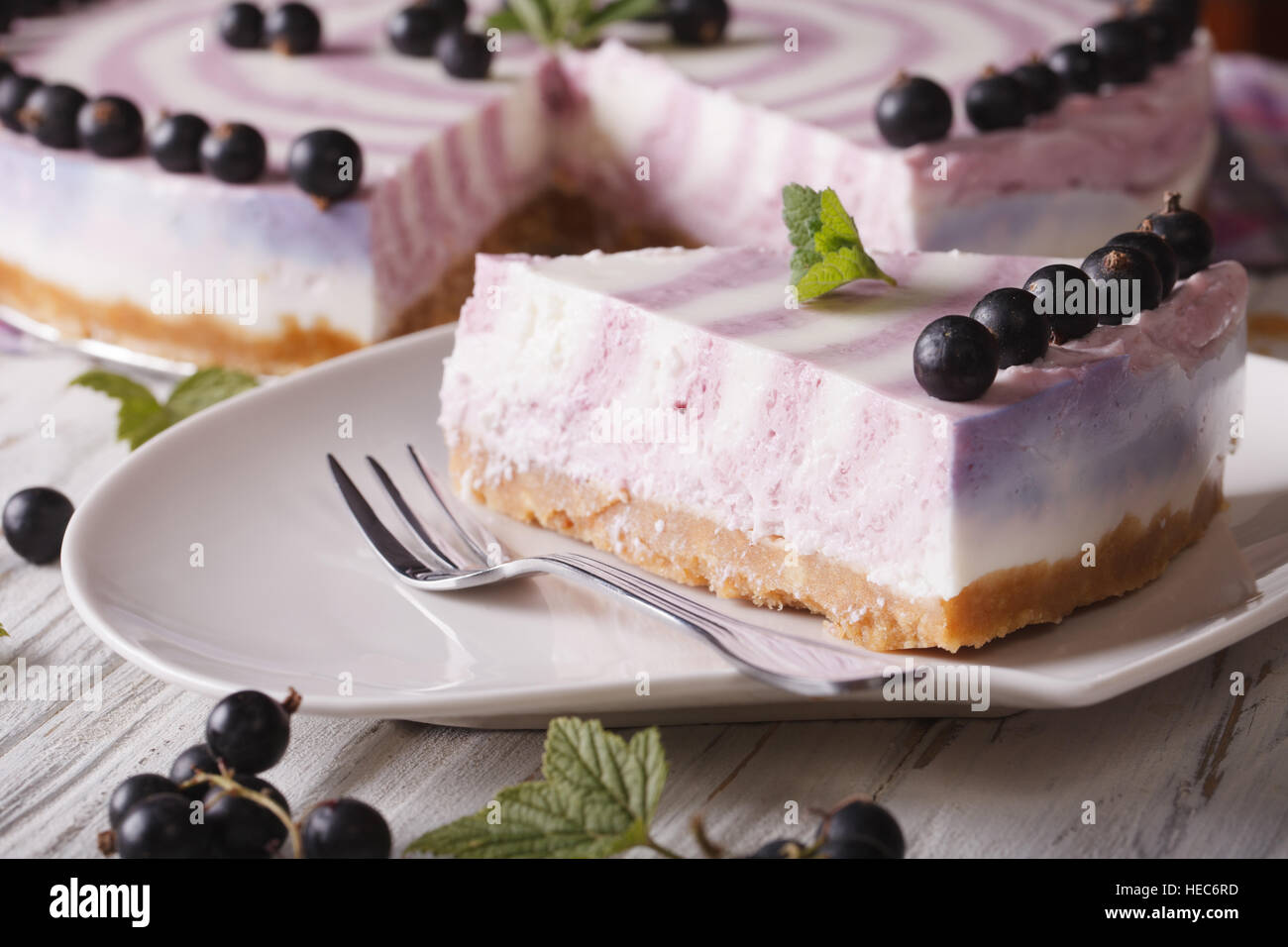 A piece of cheesecake with currant close-up on a plate. horizontal Stock Photo