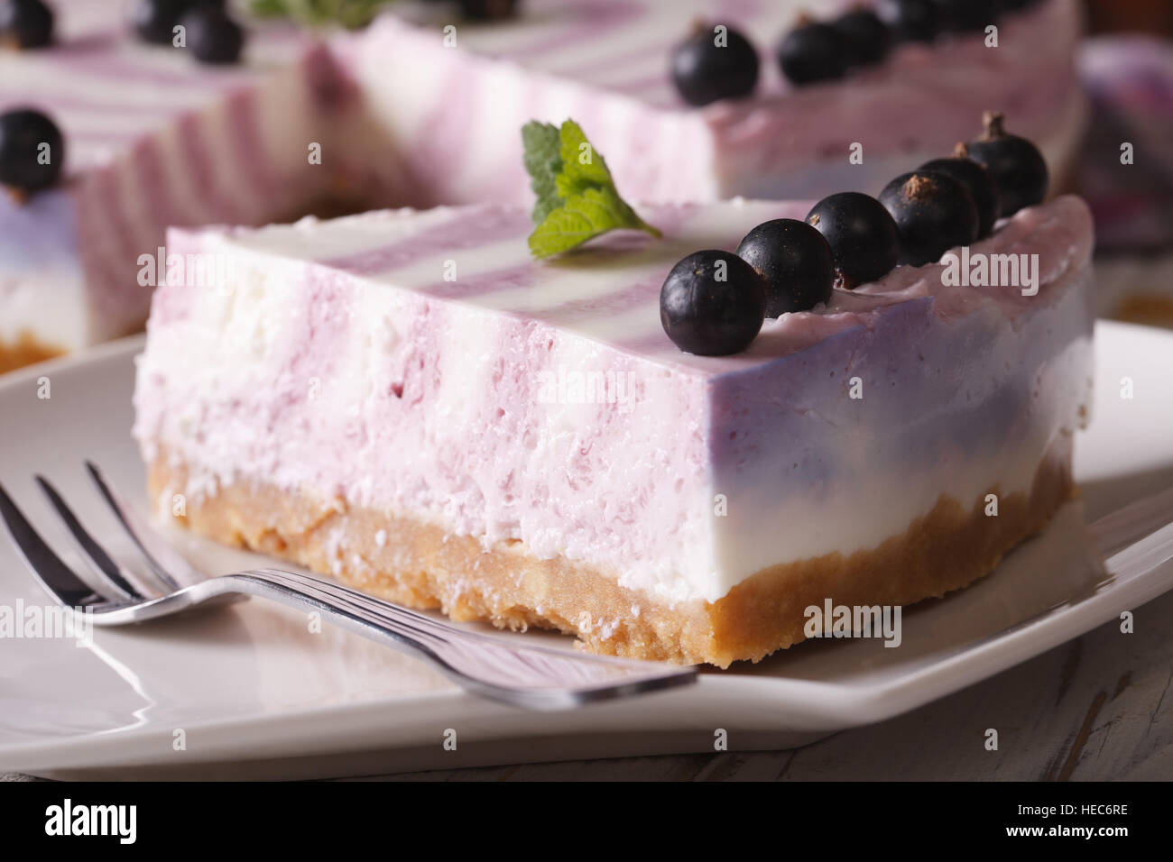 A piece of cheese cake with currants close-up on a plate. horizontal Stock Photo