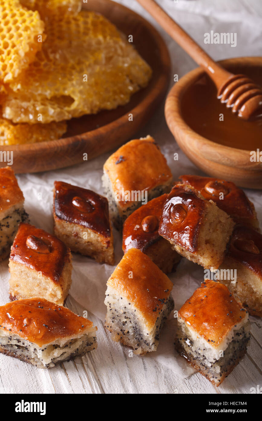 Baklava Honey with poppy seeds and nuts close-up on a table, and a honeycomb. vertical Stock Photo