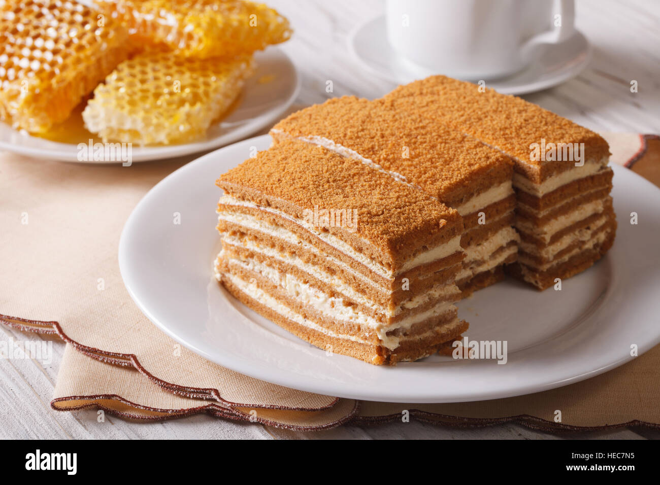 Beautiful close-up of honey cake on a plate and honeycomb. horizontal Stock Photo