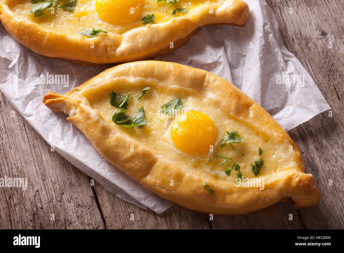 Ajarian khachapuri with egg and cheese close-up on the table. horizontal view from above Stock Photo