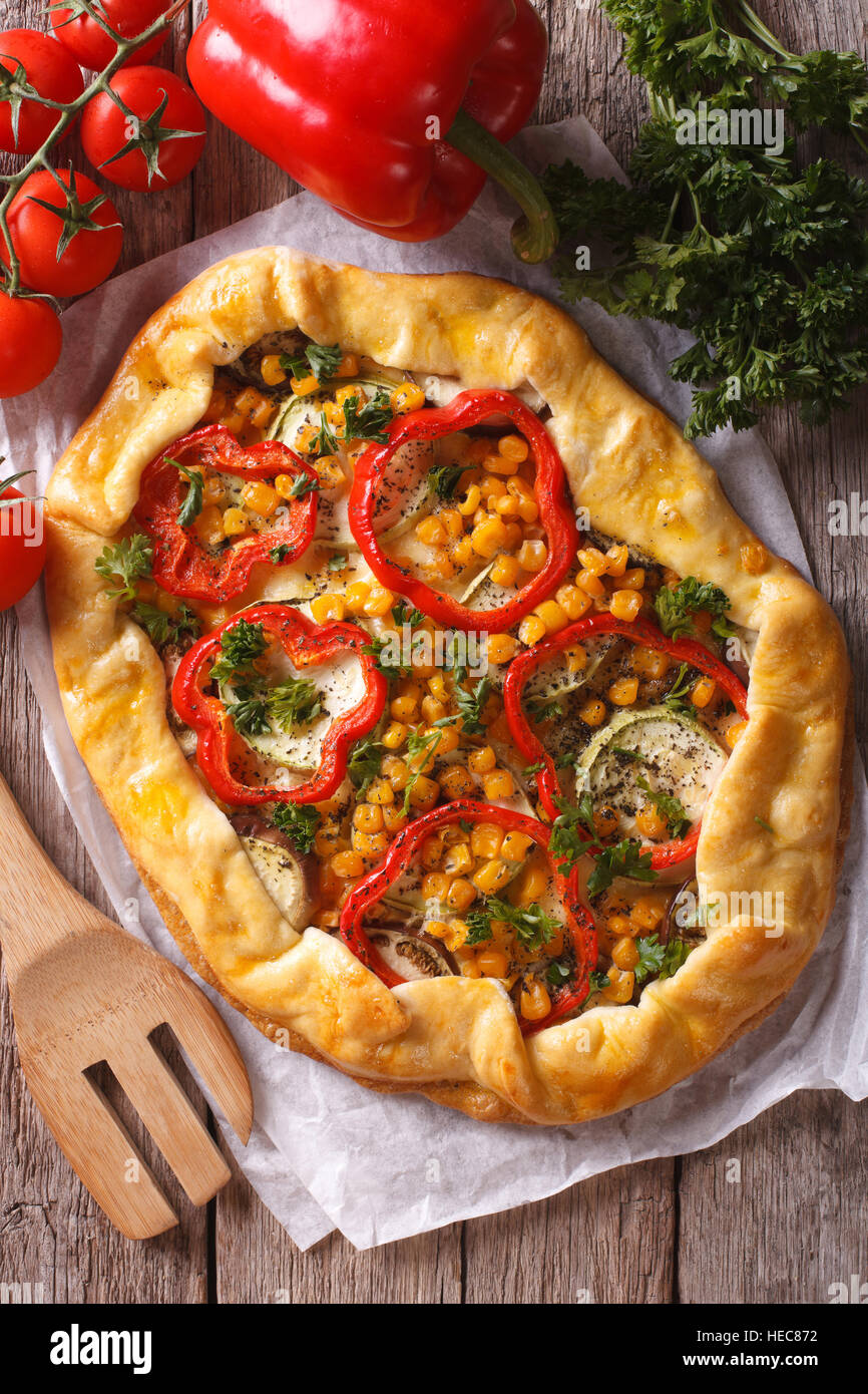 Rustic vegetable pie on a table close-up and ingredients. vertical top view Stock Photo