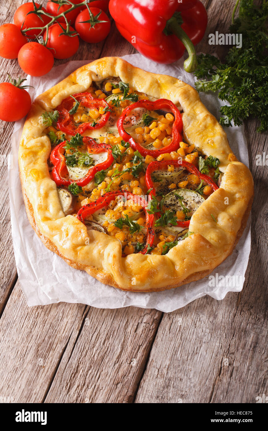 rustic vegetable pie on a table close-up and ingredients. Vertical Stock Photo