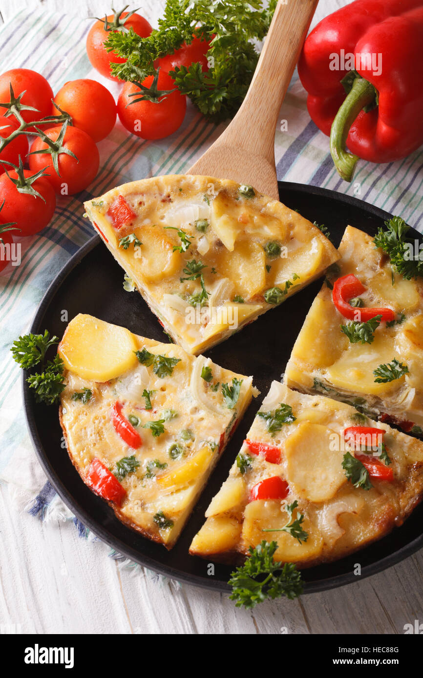 Pieces of traditional Spanish tortilla with fried potatoes closeup