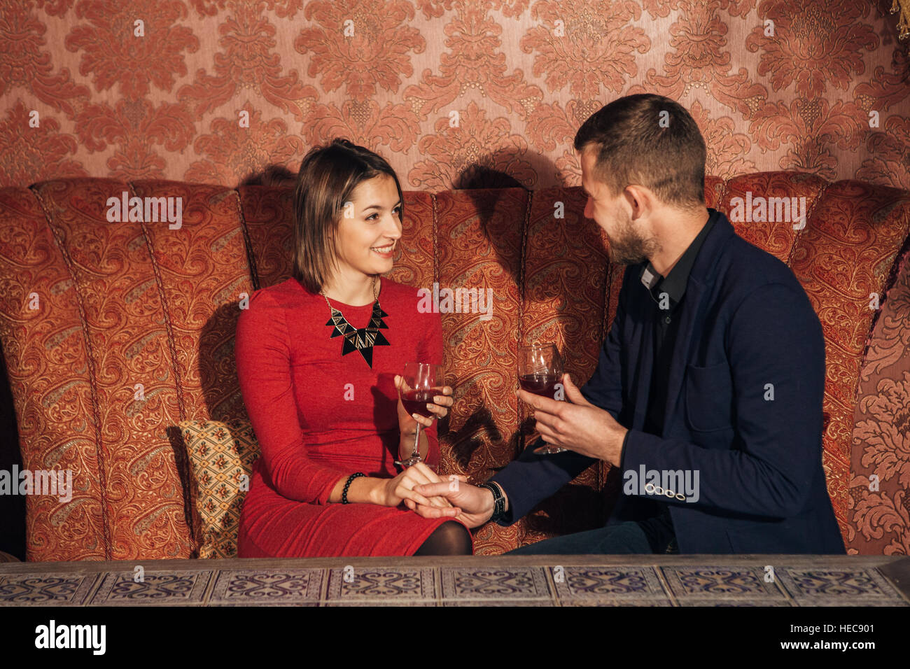 young couple flirting at restaurant and drinking wine Stock Photo Alamy