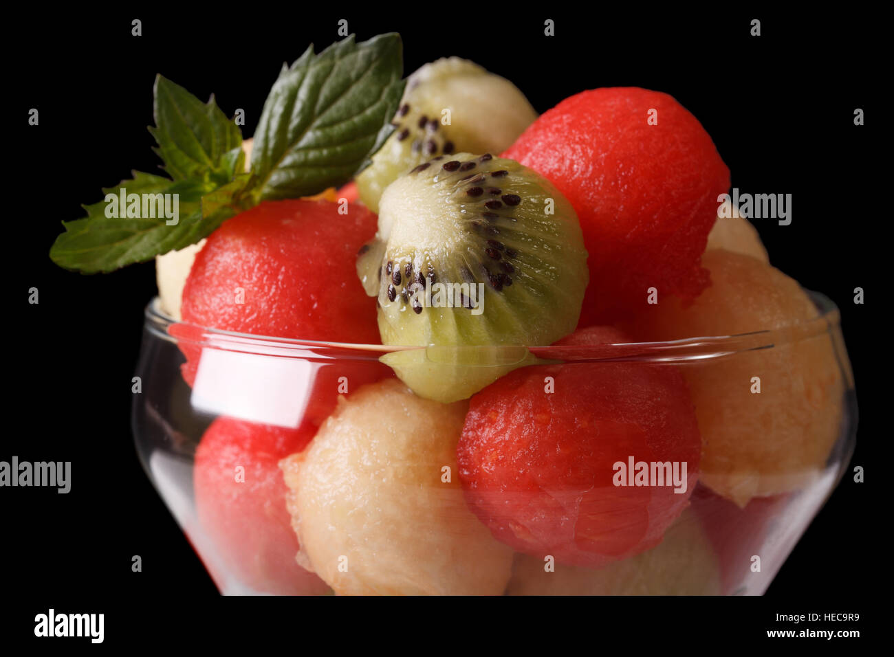 Fruit salad with watermelon, kiwi and melon in a glass macro. horizontal Stock Photo