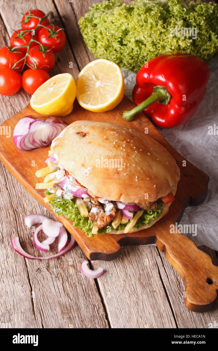 Doner kebab with meat and vegetables in pita bread closeup. vertical