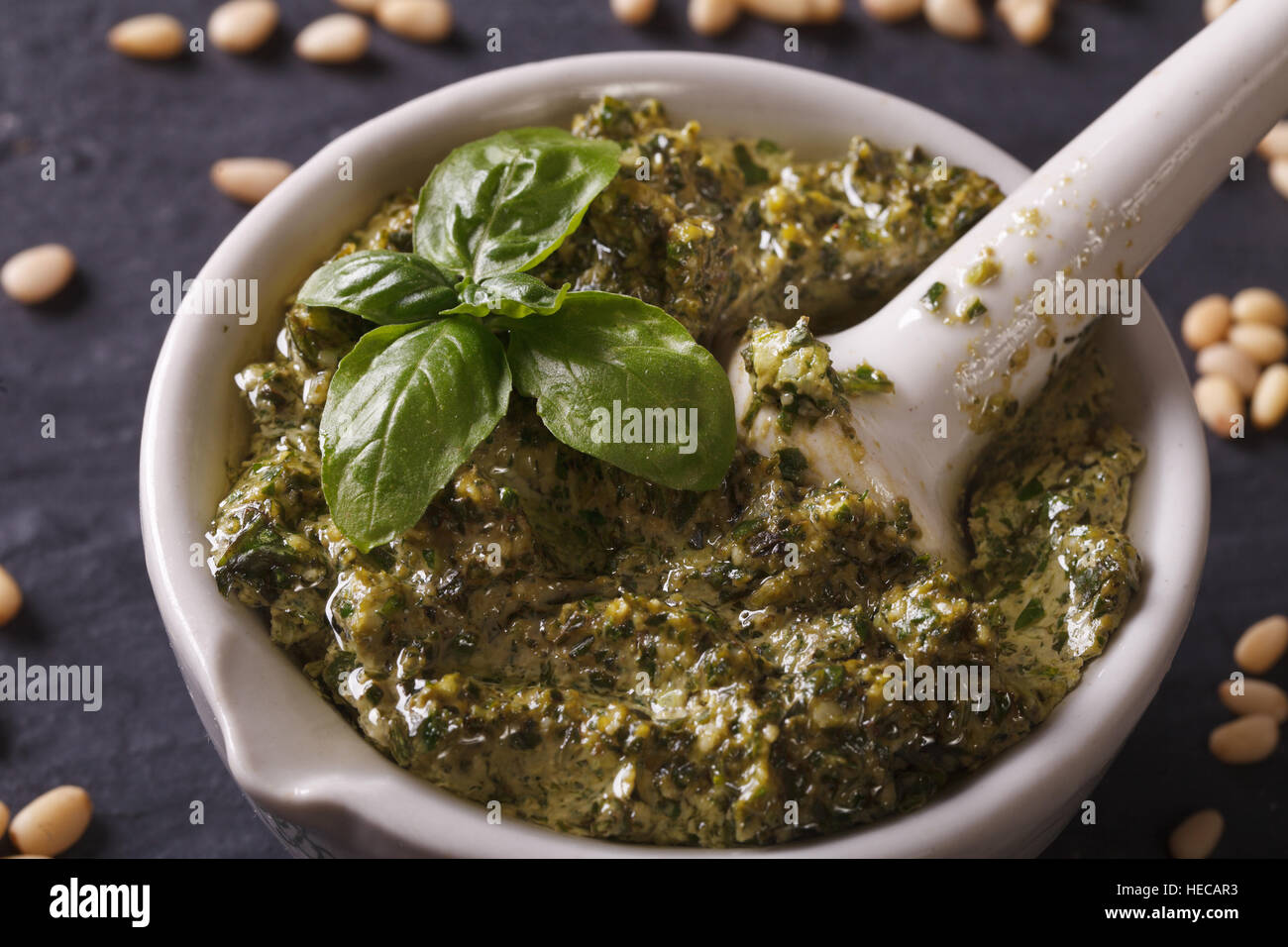 Italian pesto sauce in a mortar close-up on the table. horizontal Stock Photo