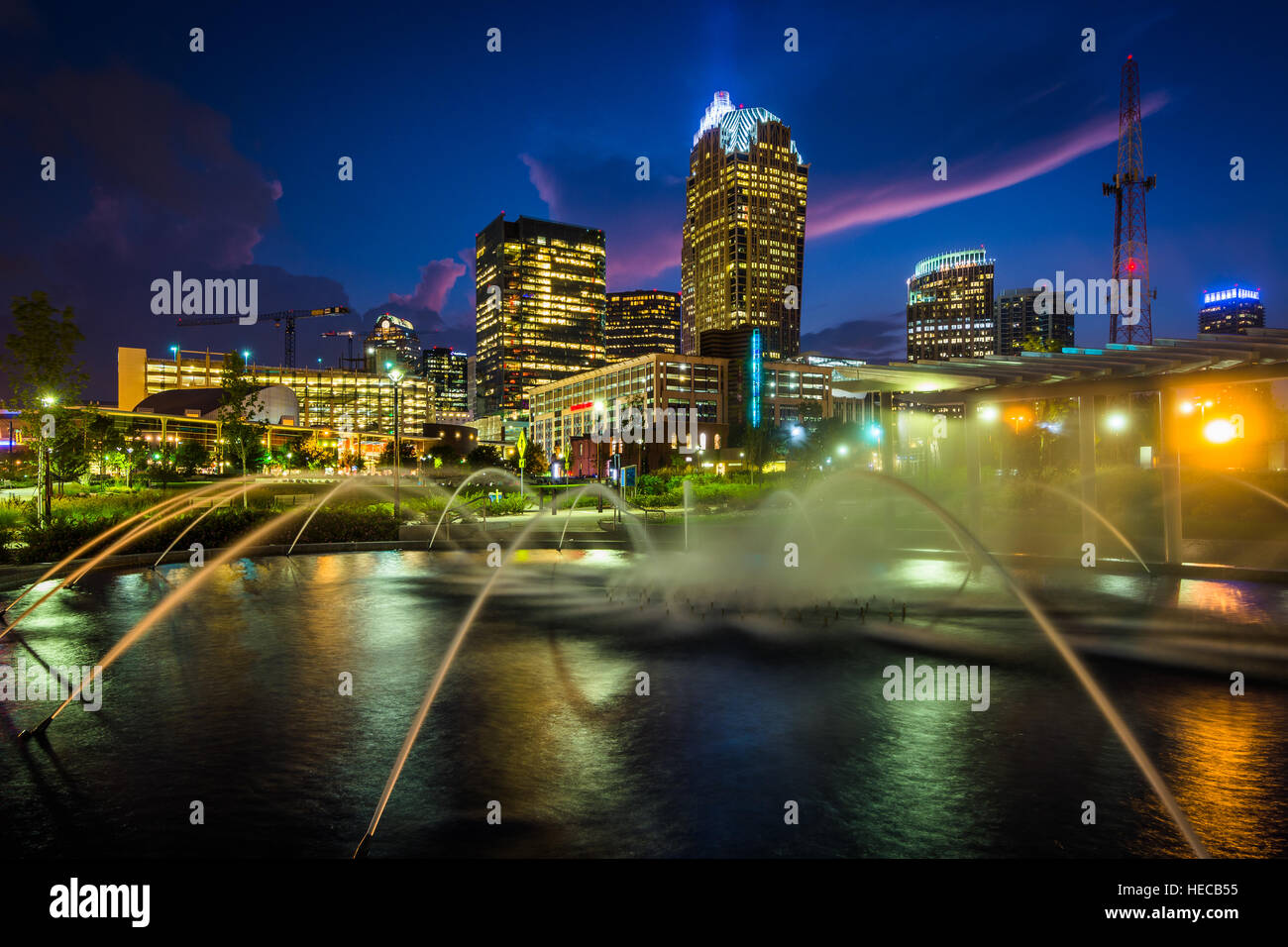 Fountains and the Charlotte skyline at First Ward Park at night, in