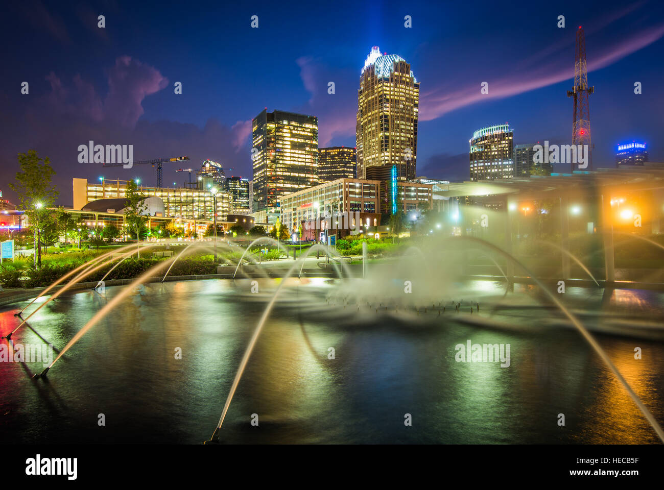 Fountains and the Charlotte skyline at First Ward Park at night, in