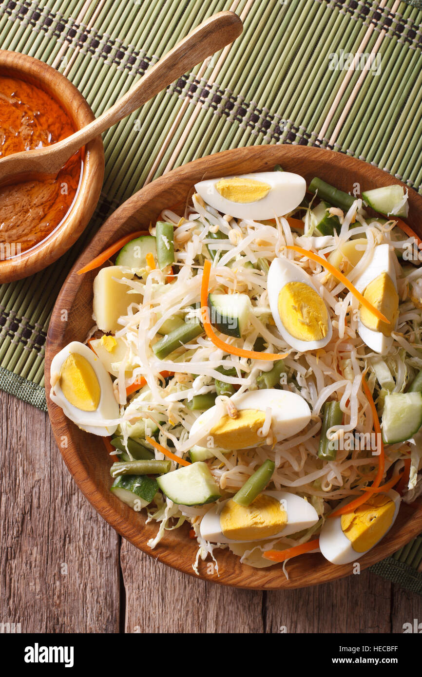 Gado Gado salad with peanut sauce closeup on the table. vertical top
