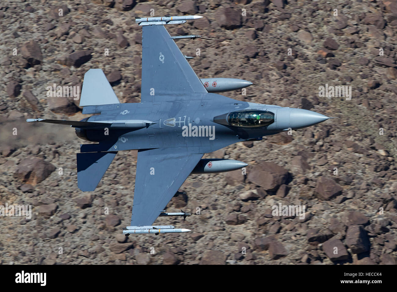 US Air Force F-16C, Flying At Low Level Through Rainbow Canyon, California. Stock Photo