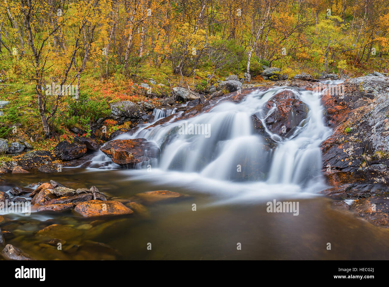 Waterfall in autumnal landscape Stock Photo