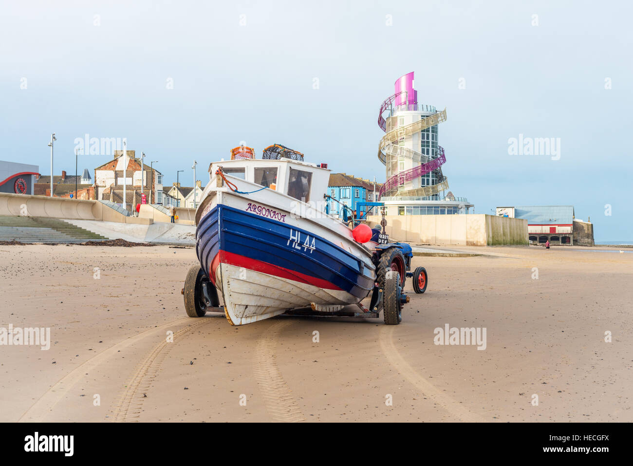 Redcar beach in Cleveland at low tide with a fishing boat on the sand