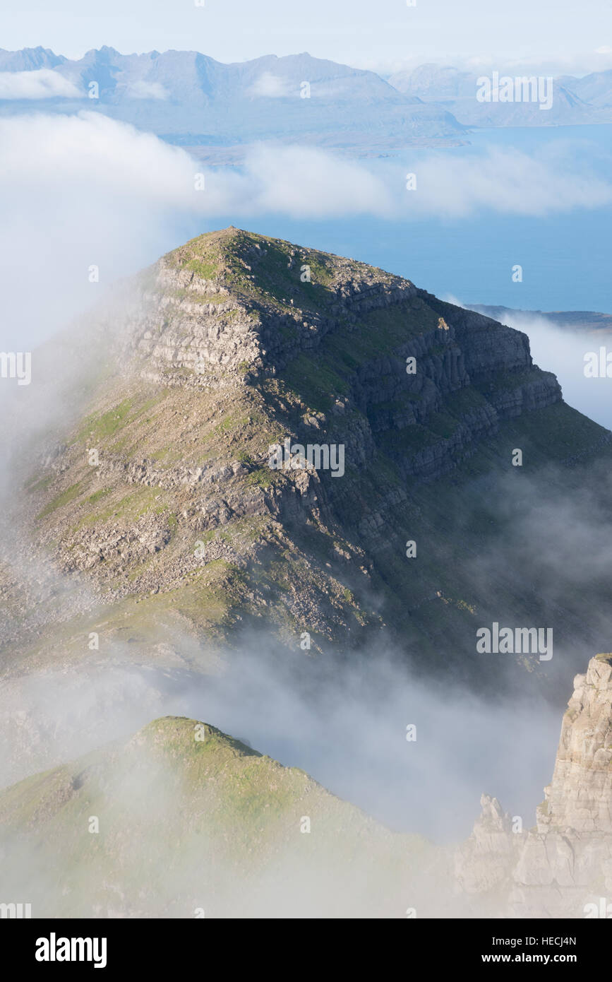 Hallival mountain emerging from mist, looking towards the Isle of Skye, Isle of rum, Inner Hebrides, Scotland, UK Stock Photo