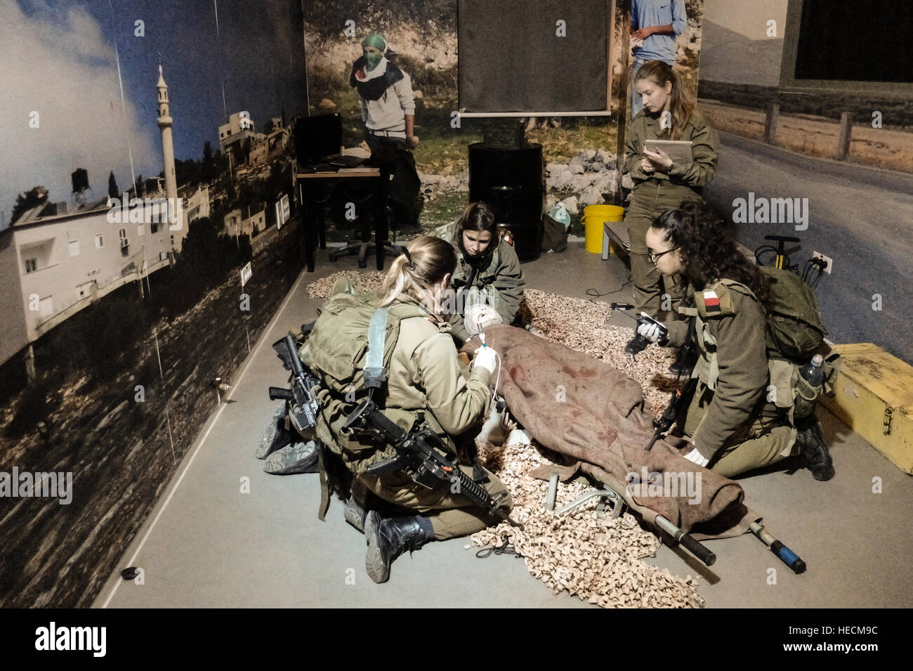 Camp Ariel Sharon, Israel. 19th December, 2016. Soldiers train in emergency medical treatment in simulation rooms mocking a combat environment in the IDF's recently inaugurated City of Training Bases, or Camp Ariel Sharon. The base is part of project to relocate IDF bases to the Negev in Israel's south, returning expensive land in central Israel to the country's Lands Administration and to develop the Negev by creating thousands of new jobs. Credit: Nir Alon/Alamy Live News Stock Photo