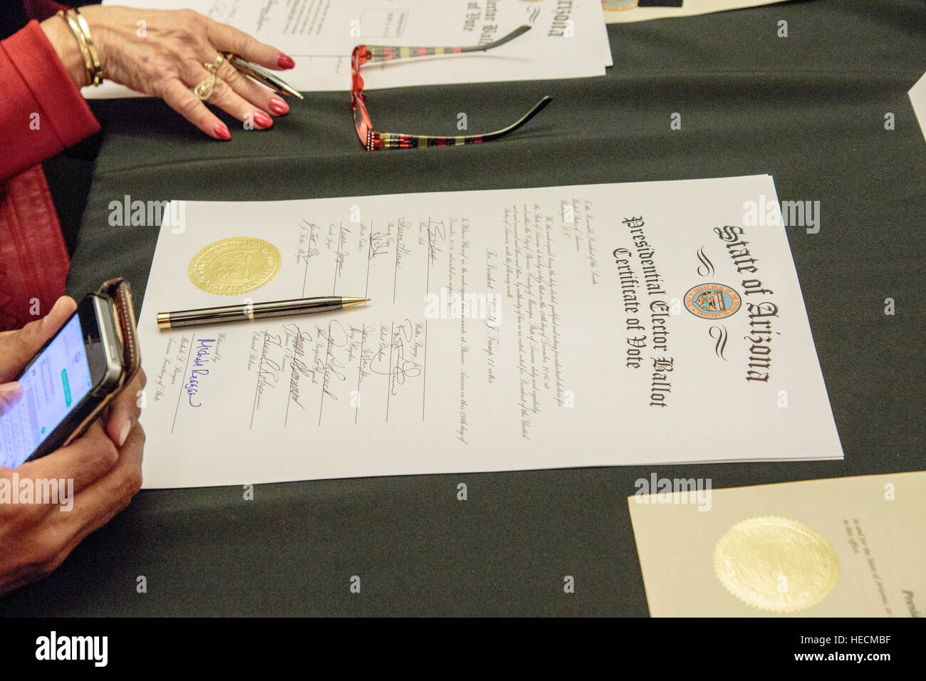 Phoenix, Arizona, USA. 19th December, 2016. Presidential electors cast their vote for Donald Trump during the Meeting of the Electoral College at the Arizona State Capitol. Despite protests outside the building, all eleven electors cast their vote in accordance with the popular vote of Arizona. © Jennifer Mack/Alamy Live News Stock Photo