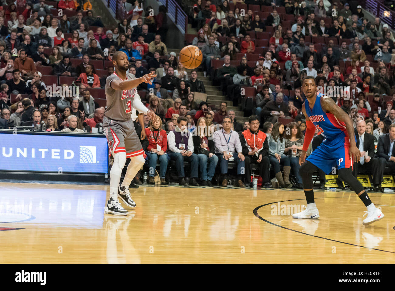 Chicago, USA.  19 December 2016. Bulls guard (#3), Dwyane Wade, makes a pass watched by Pistons guard (#5), Kentavious Caldwell-Pope, during the Chicago Bulls vs Detroit Pistons game at the United Center in Chicago. Final score - Detroit Pistons 82, Chicago Bulls 113.  © Stephen Chung / Alamy Live News Stock Photo