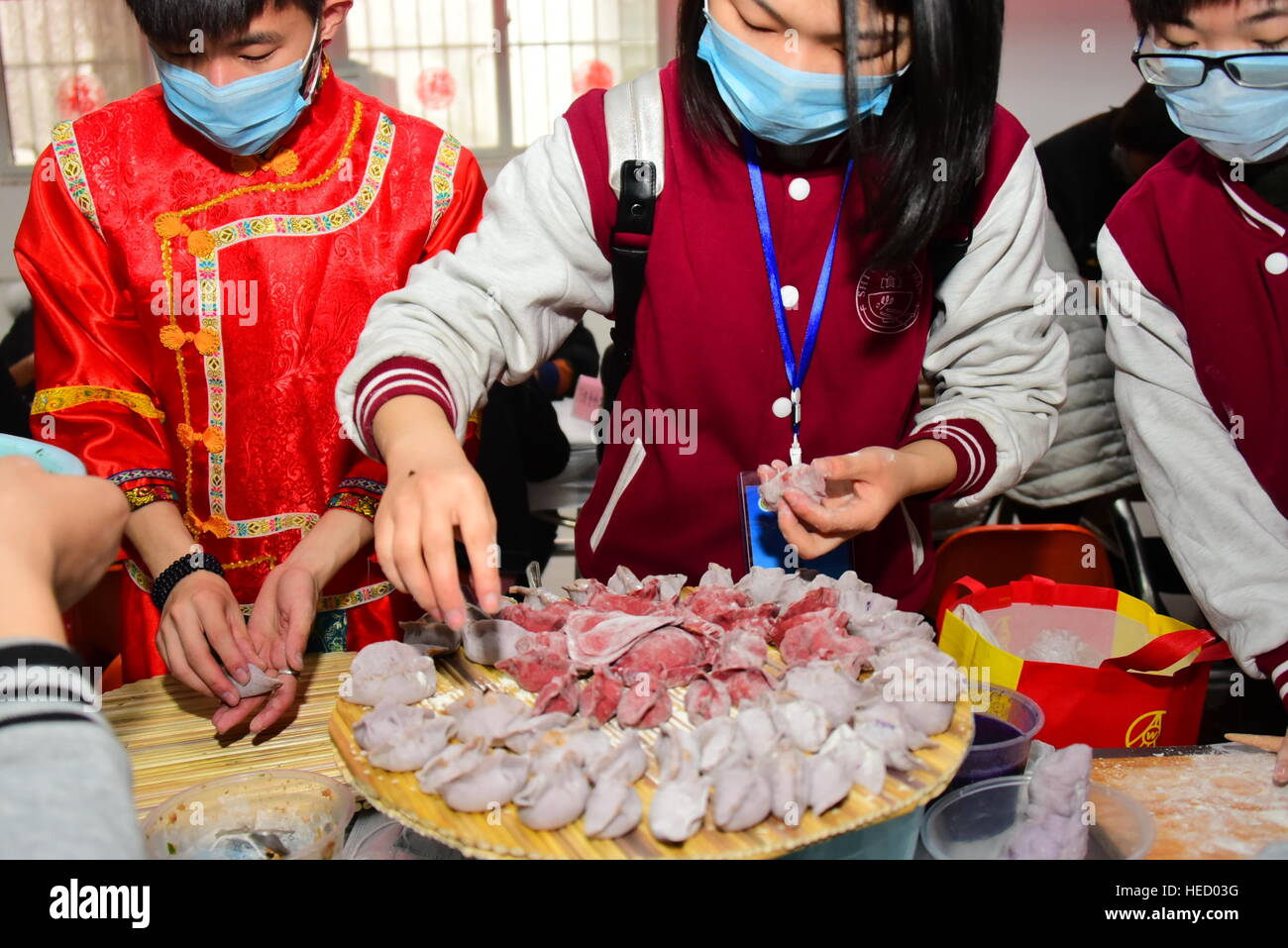 Zhengzhou, Zhengzhou, China. 20th Dec, 2016. Zhengzhou, CHINA-December 20 2016: (EDITORIAL USE ONLY. CHINA OUT) .Students make thousands of dumplings for street cleaners at Henan University of Agriculture in Zhengzhou, capital of central China's Henan Province, December 20th, 2016, marking the solar term 'Winter Solstice'. The dumplings were laid in a pattern of the Chinese character 'Fu' which means good luck. The traditional Chinese lunar calendar divides the year into 24 solar terms. Winter Solstice, the 22nd solar term of the year, begins this year on Dec 21 and ends on Jan 4. On the Stock Photo
