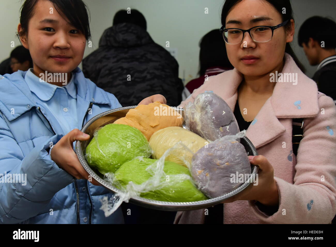 Zhengzhou, Zhengzhou, China. 20th Dec, 2016. Zhengzhou, CHINA-December 20 2016: (EDITORIAL USE ONLY. CHINA OUT) .Students make thousands of dumplings for street cleaners at Henan University of Agriculture in Zhengzhou, capital of central China's Henan Province, December 20th, 2016, marking the solar term 'Winter Solstice'. The dumplings were laid in a pattern of the Chinese character 'Fu' which means good luck. The traditional Chinese lunar calendar divides the year into 24 solar terms. Winter Solstice, the 22nd solar term of the year, begins this year on Dec 21 and ends on Jan 4. On the Stock Photo