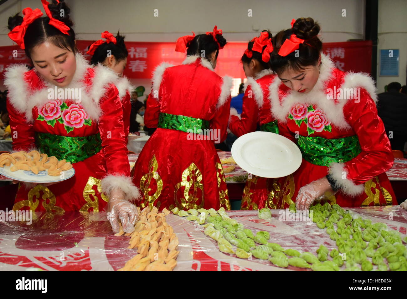 Zhengzhou, Zhengzhou, China. 20th Dec, 2016. Zhengzhou, CHINA-December 20 2016: (EDITORIAL USE ONLY. CHINA OUT) .Students make thousands of dumplings for street cleaners at Henan University of Agriculture in Zhengzhou, capital of central China's Henan Province, December 20th, 2016, marking the solar term 'Winter Solstice'. The dumplings were laid in a pattern of the Chinese character 'Fu' which means good luck. The traditional Chinese lunar calendar divides the year into 24 solar terms. Winter Solstice, the 22nd solar term of the year, begins this year on Dec 21 and ends on Jan 4. On the Stock Photo