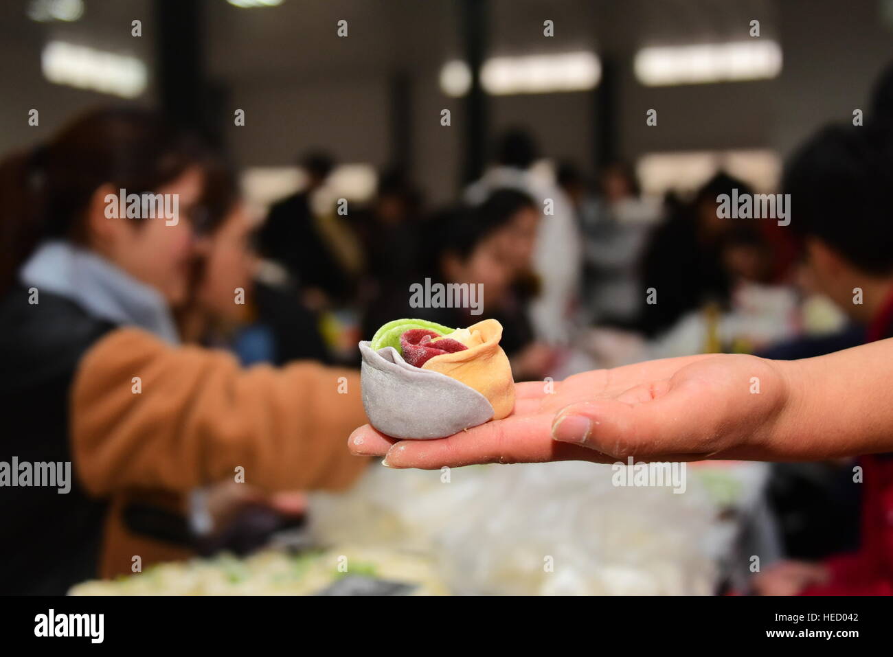 Zhengzhou, Zhengzhou, China. 20th Dec, 2016. Zhengzhou, CHINA-December 20 2016: (EDITORIAL USE ONLY. CHINA OUT) .Students make thousands of dumplings for street cleaners at Henan University of Agriculture in Zhengzhou, capital of central China's Henan Province, December 20th, 2016, marking the solar term 'Winter Solstice'. The dumplings were laid in a pattern of the Chinese character 'Fu' which means good luck. The traditional Chinese lunar calendar divides the year into 24 solar terms. Winter Solstice, the 22nd solar term of the year, begins this year on Dec 21 and ends on Jan 4. On the Stock Photo