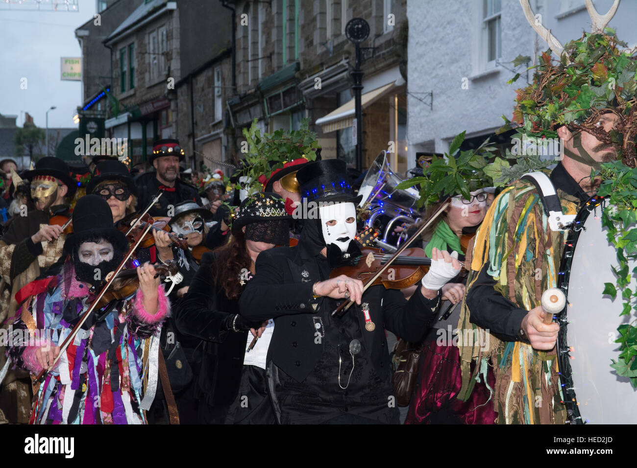 Penzance, Cornwall, UK. 21st December 2016. The annual Montol festival held on the date of the feast of St Thomas the Apostle and the winter solstice. Guise processions and lantern parades take place leading to the chalking of the Mock. The first parade seen here at sundown. Credit: Simon Maycock/Alamy Live News Stock Photo
