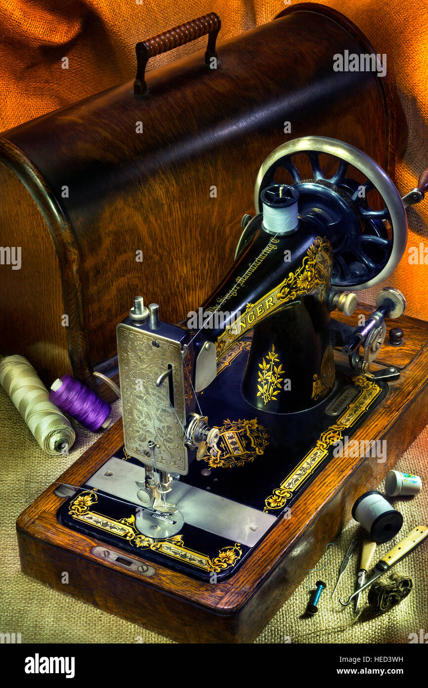 An antique Singer 12 Sewing Machine with gold decoration. Stock Photo