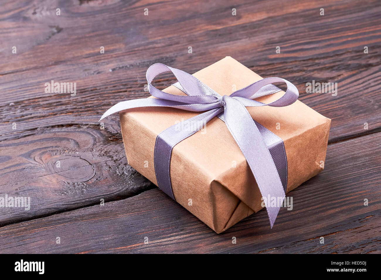 Present box on wooden surface. Stock Photo