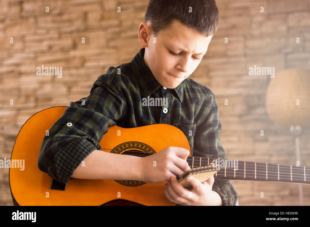 Boy with Acoustic Guitar Writing Songs in Living Room Stock Photo Alamy