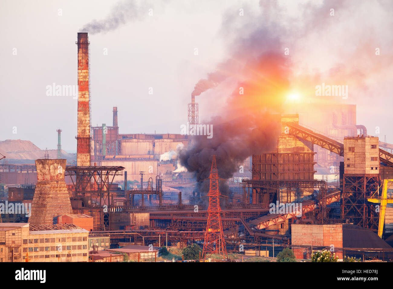 Metallurgy plant in Ukraine at sunset. Steel factory with smog. Pipes with smoke. Steel mill. Heavy industry factory. plant Stock Photo