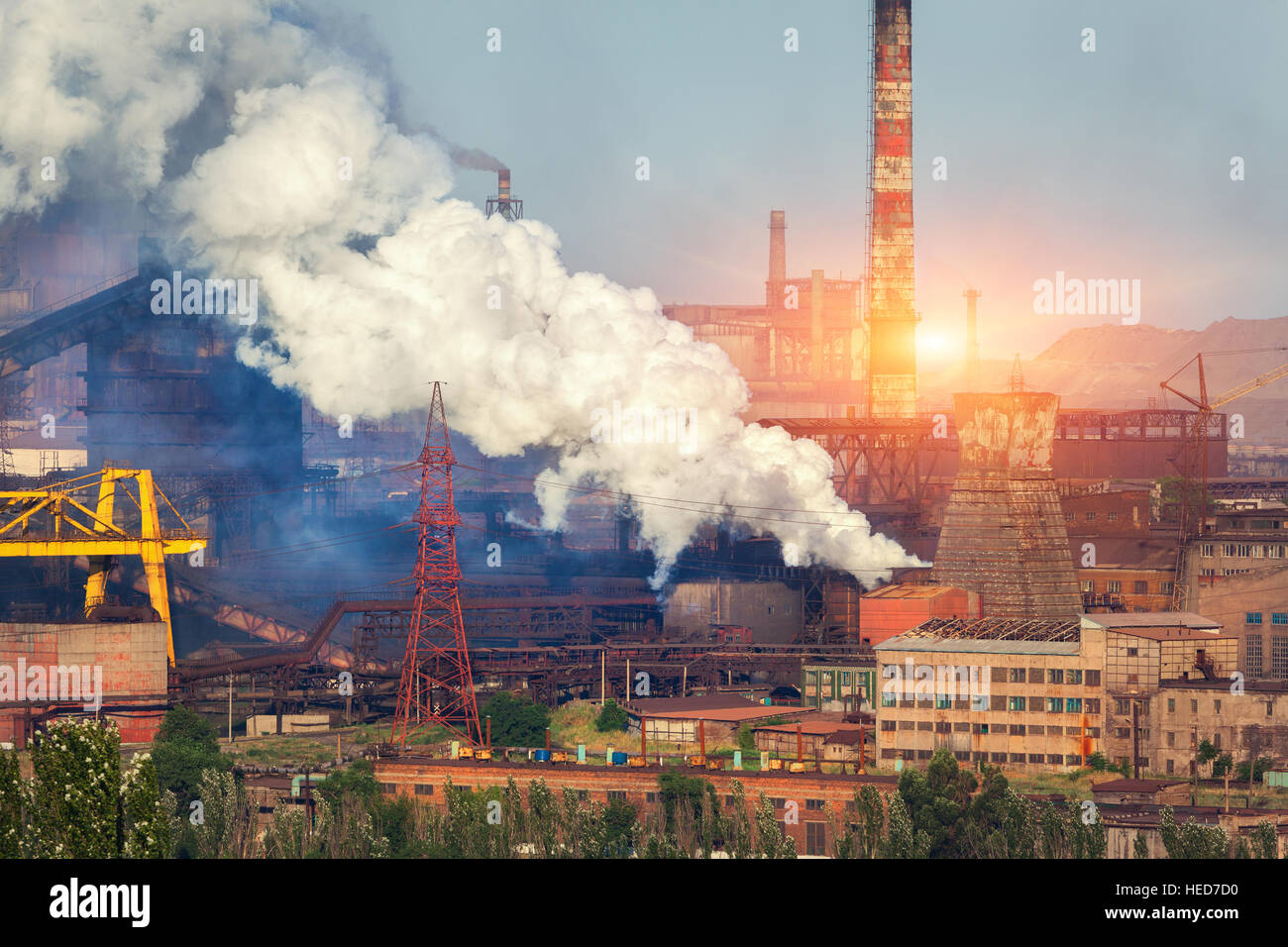Metallurgy plant in Ukraine at sunset. Steel factory with smog. Pipes with smoke. Steel mill. Heavy industry factory. plant Stock Photo