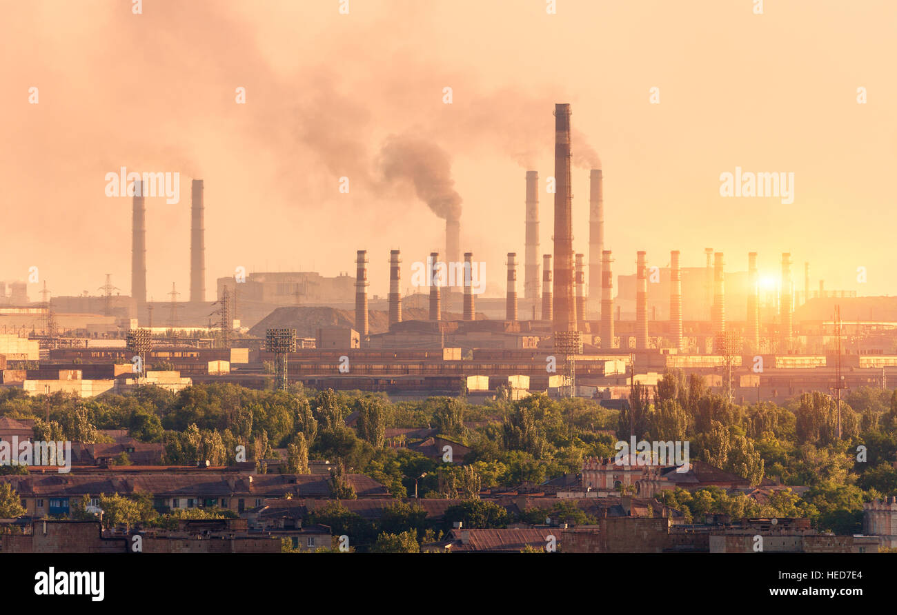 Metallurgy plant at sunset. Steel mill. Heavy industry factory. Steel factory with smog. Pipes with smoke. Metallurgical plant Stock Photo