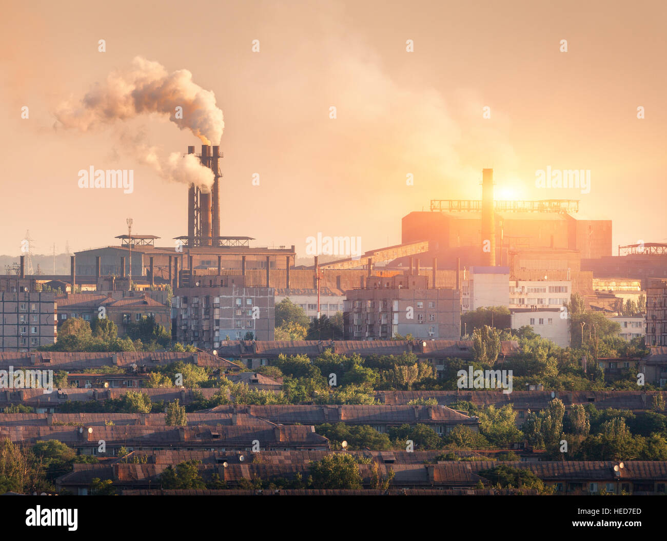 Metallurgy plant at sunset. Steel mill. Heavy industry factory. Steel factory with smog. Pipes with smoke. Metallurgical plant Stock Photo