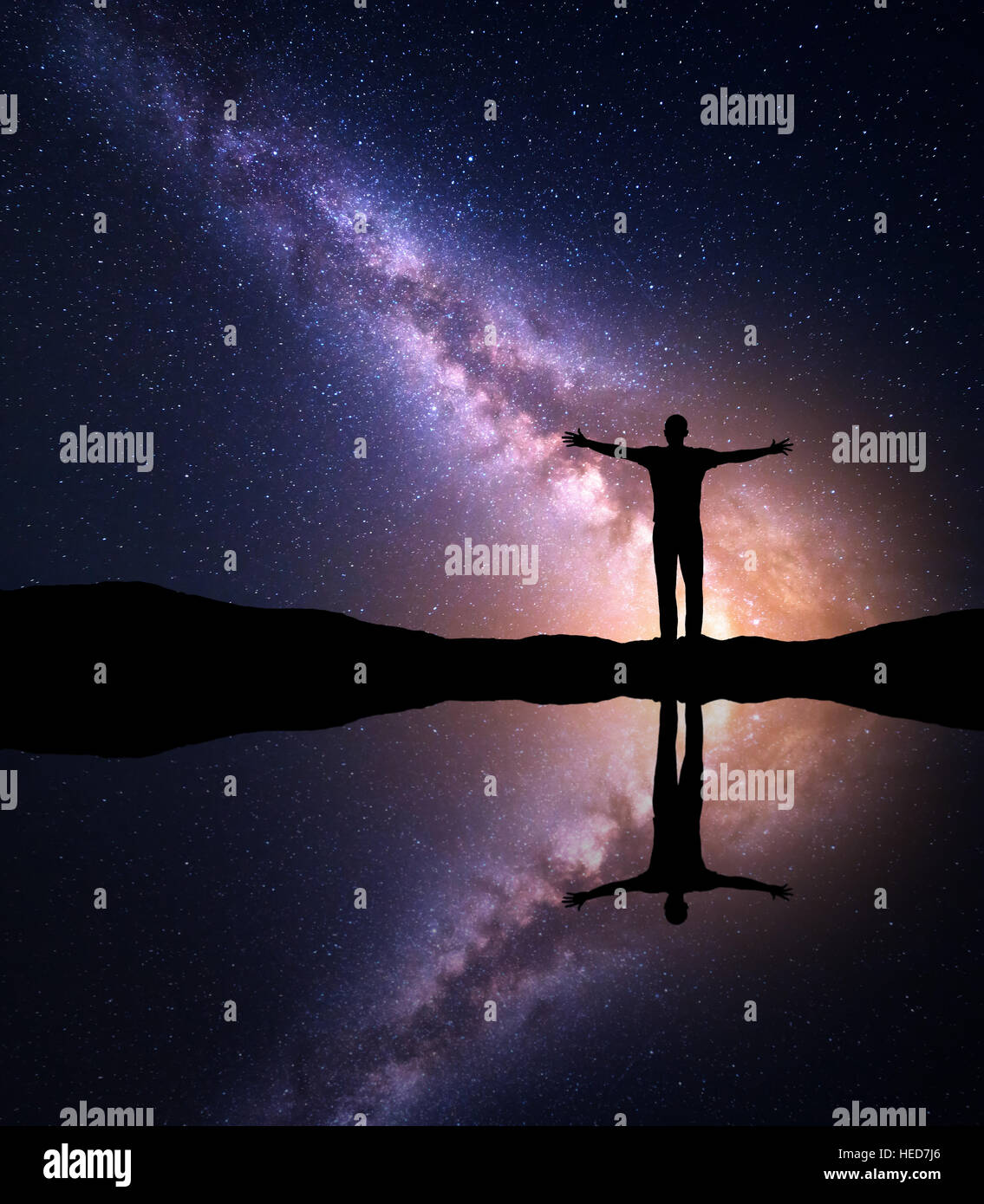Milky Way. Night starry and silhouette of a man with with raised up ...