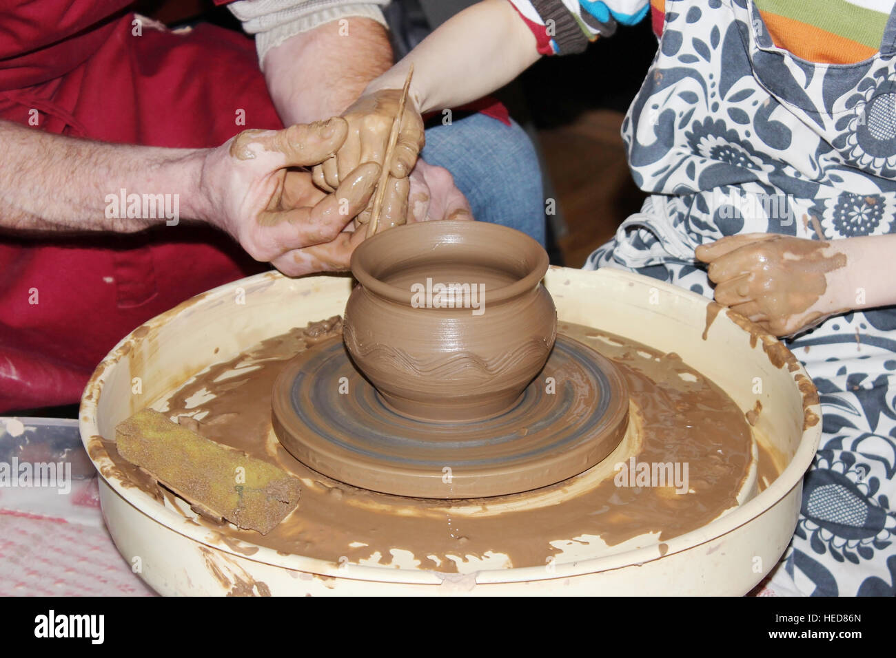 experienced master potter teaches the art of making pots clay on the 's wheel Stock Photo Alamy
