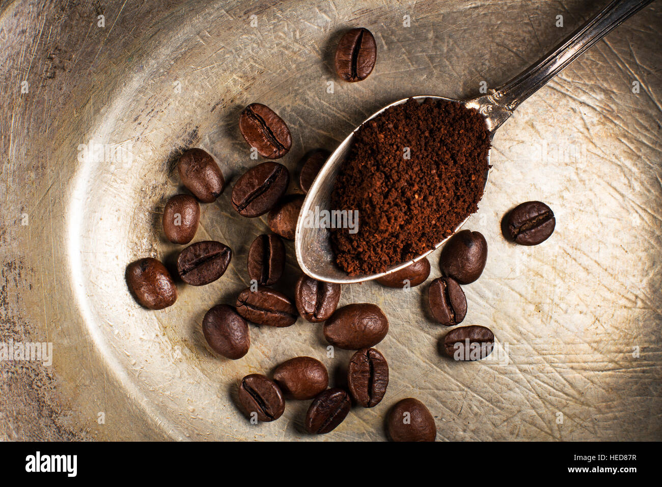 Fresh ground Coffee in spoon on plate close up. Stock Photo