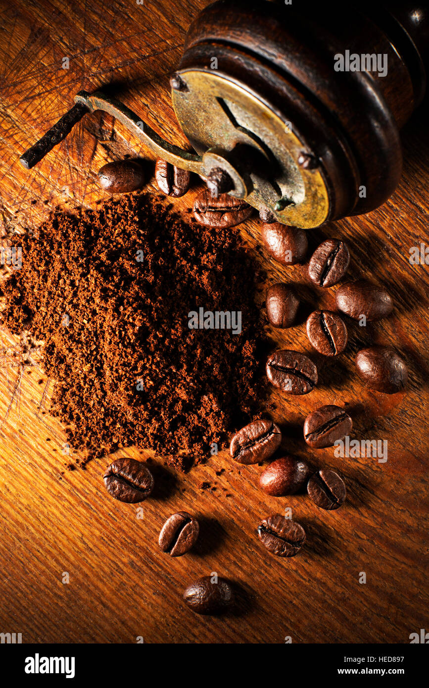 Fresh ground Coffee with hand grinder on wooden background. Stock Photo