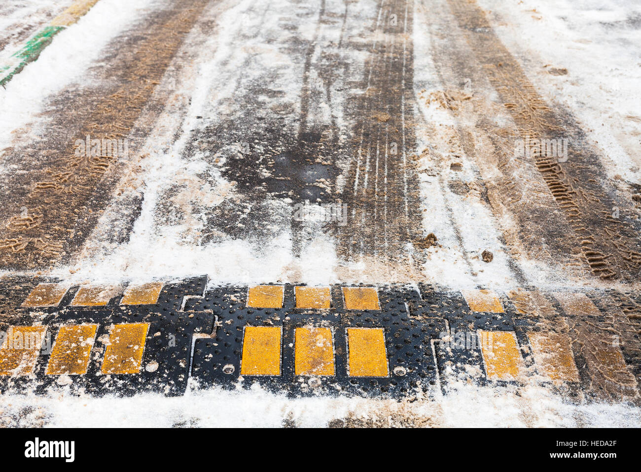 speed bump in snow on urban road in winter day Stock Photo Alamy
