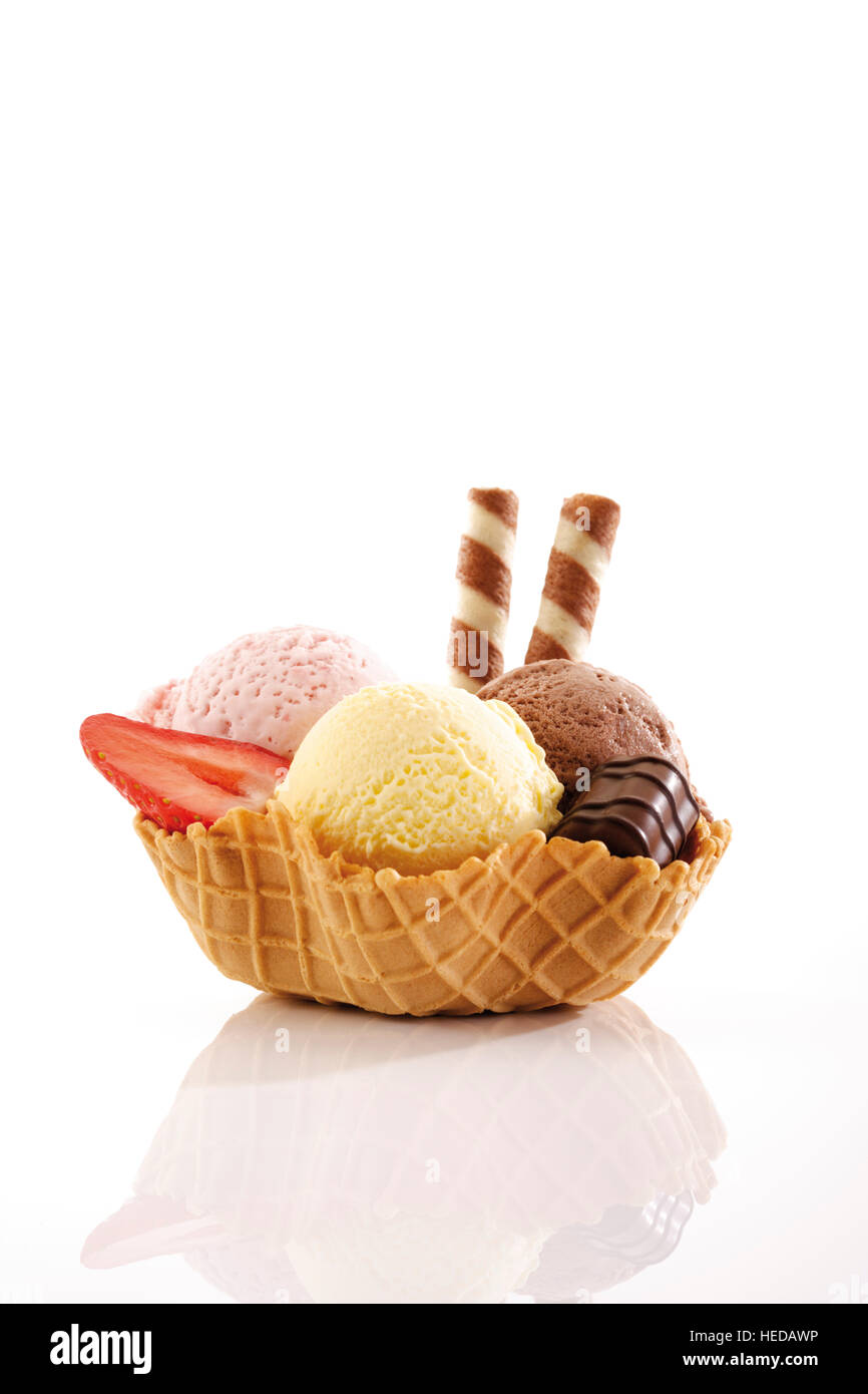 Strawberry, vanilla and chocolate ice cream, praline and wafer rolls in