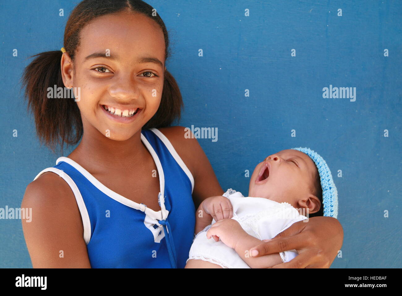 Girl holding a baby, Trinidad, SanctiSpíritus Province, Cuba, Latin