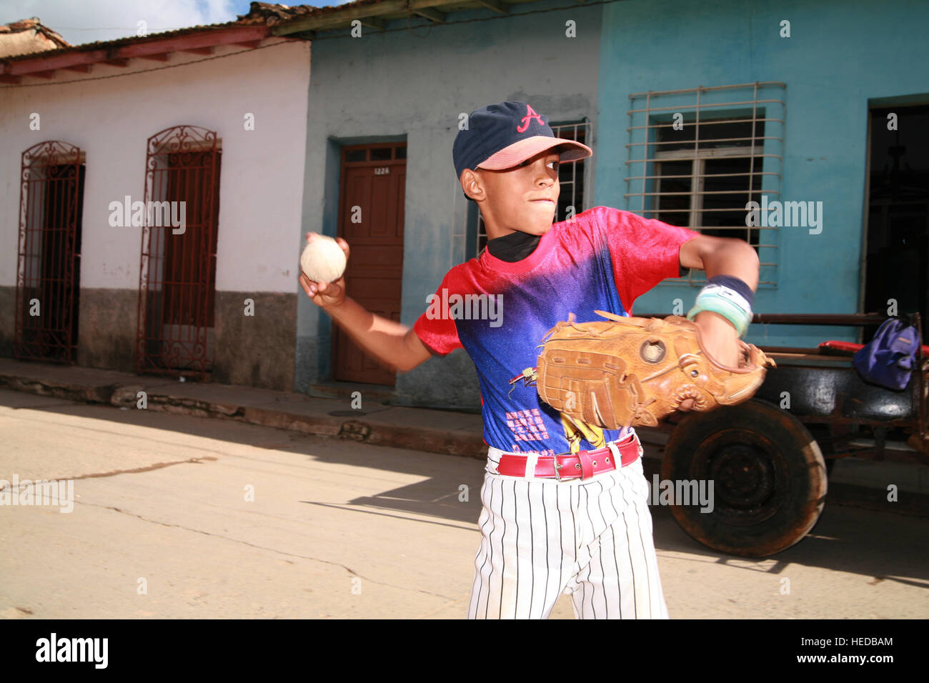 Boy playing baseball on a street in Trinidad, Sancti-Spíritus Province, Cuba, Latin America Stock Photo